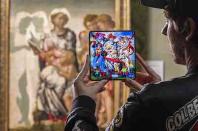 Philip Colbert, a pop artist, uses a OnePlus phone to complete his take on The Madonna and Child with St John and Angels, also known as the Manchester Madonna, an unfinished painting by Michelangelo in the National Gallery