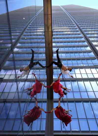 The Italian dance company Il Posto perform at the base of Japan's tallest building, the Mori JP Tower in Tokyo, which reaches 330m